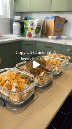 three containers filled with food sitting on top of a kitchen counter next to a sink