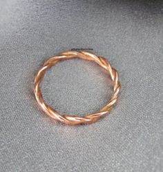 a gold ring sitting on top of a gray cloth