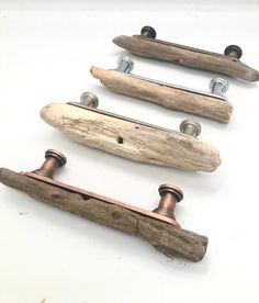 three wooden handles with metal knobs on them