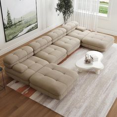 a living room with a large sectional couch and coffee table on the rug in front of it