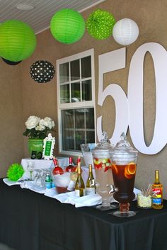 a table topped with lots of drinks and decorations