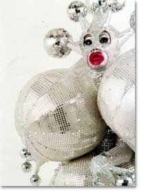 a white and silver christmas ornament with red nose