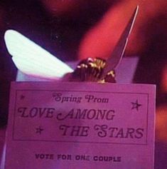 a pink sign that says love among the stars