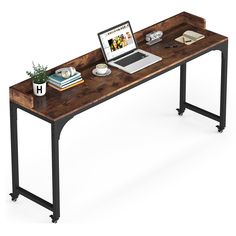 a laptop computer sitting on top of a wooden desk next to a potted plant