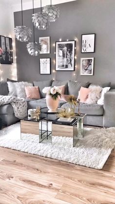 a living room filled with furniture and pictures hanging on the wall above it's coffee table