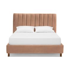 an upholstered bed with two pillows on it