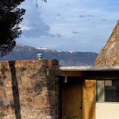 a house with a mountain in the background