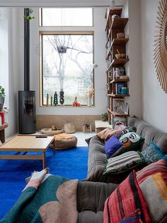 a living room filled with lots of furniture and a fire place next to a window