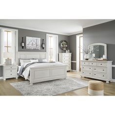 a bedroom with gray walls and white furniture