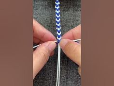 someone is knitting something with blue and white yarn