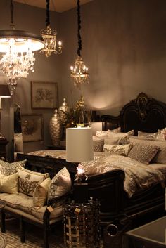 a bed room with a neatly made bed and chandelier