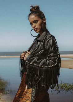 Talk about having it all! This show-stopping fringe jacket explores and reveals all the sides of you! Catch their eye wherever you go in this cool fringed black faux leather jacket that is accessorized with silver colored studs. The biker style jacket also features removable buckle fasten waist belt, front zipper closures, long sleeves, and western inspired fringe trimming and stud details at sleeves and back. This moto jacket with fringe is the perfect piece to layer over a band shirt and jeans Tassle Jacket Outfits, Boho Leather Jacket, Fringe Jacket Outfit, Woman Leather Jacket, Biker Jacket Outfit, Western Gothic, Leather Fringe Jacket, Tassel Jacket, Aesthetic Pose