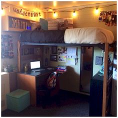 a bunk bed with a desk underneath it in a room that has lights on the ceiling