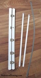 an assortment of white door handles on a wood floor with metal bars and nails attached to them