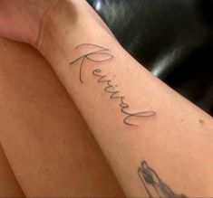 a woman's arm with the word faith written in cursive writing on it