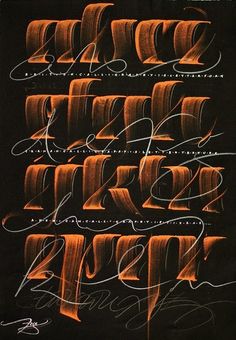 some type of calligraphy that is written in orange and white ink on black paper