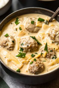 a bowl filled with meatballs and cheese sauce