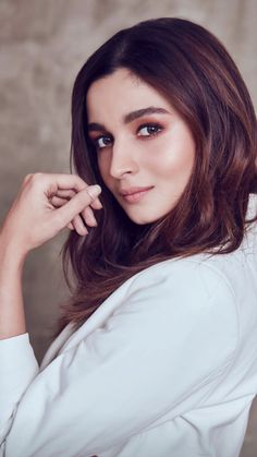 an image of a woman with long hair posing for the camera and looking at the camera