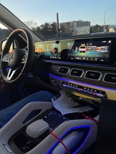 the interior of a car with an electronic display on the dash board and steering wheel