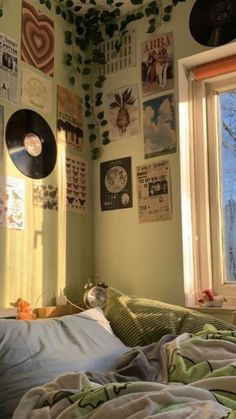 a bedroom with green walls and pictures on the wall