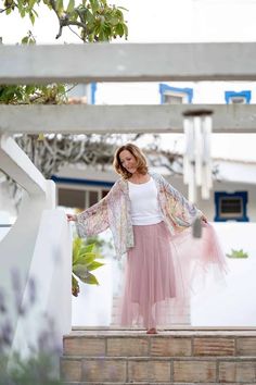 A woman wearing a flowing pink skirt and a patterned shawl stands on steps near a white building, expertly captured by a brand photographer. Successful Women Aesthetic, Everyday Life Photography, The Art Of Photography, Successful Woman, Art Of Photography