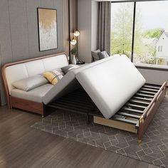 a bed with two mattresses on top of it in a room next to a window