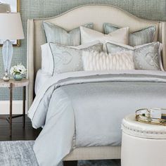 a bedroom with a bed, nightstands and lamps on the side tables in front of it