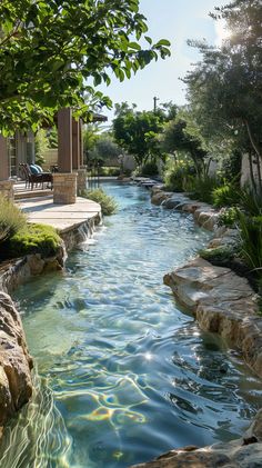 an outdoor swimming pool surrounded by rocks and greenery