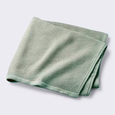 a green towel folded on top of each other