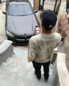 a young boy walking up the stairs to his car