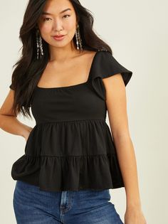 This short sleeve top with charming ruffle tiering and a tie back closure is a wardrobe essential, adding a touch of feminine flair to your everyday style. The delightful ruffle details elevate its appeal, making it a versatile and timeless staple that effortlessly complements various outfits. Party Fits Casual, Flowy Tops Outfit, Ruffle Tops Outfit, Black Top Summer, Ruffle Top Blouses, Party Fits, Fancy Tops, Senior Picture Outfits, Feminine Top