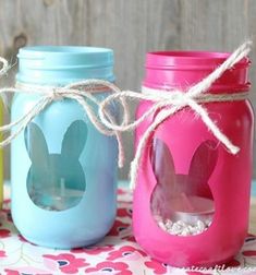 three mason jars with bunny ears painted on them