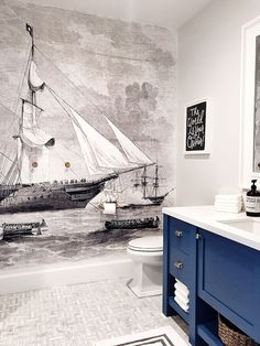 a bathroom with a large mural on the wall