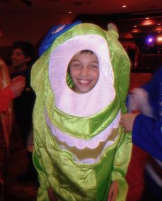 a young boy dressed as a green monster