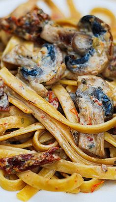 pasta with mushrooms and sauce on a white plate