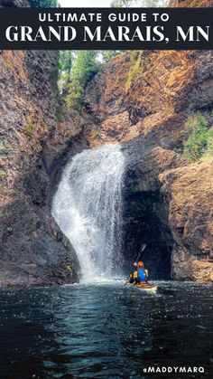 a person in a kayak near a waterfall