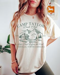 a woman wearing a camp taylor t - shirt