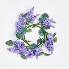 purple flowers and green leaves arranged in a circle