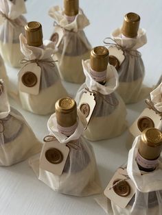 several bottles of wine wrapped in white paper