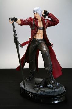 an action figure is posed on top of a black base with a red coat and long white hair