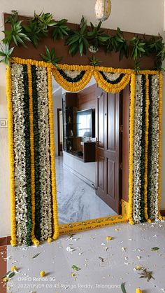 a large mirror decorated with flowers and greenery