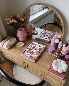 a vanity with cosmetics and flowers on it