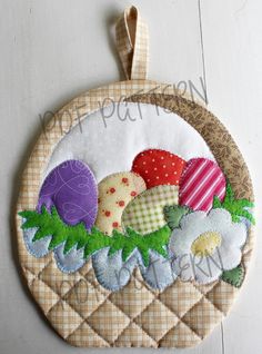 an embroidered ornament with flowers and eggs on it