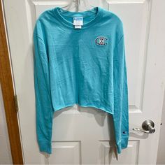 Brand: Champion Size: Women's Size Medium, Tag Says Loose So Maybe Will Fit A Large Too?, Measurements In Pictures Condition: New With Tags, Wrinkled From Being In A Tote Very Pretty Blue Color. Signature C Patch On Upper Front Side And On The Arm. Raw Hem. Long Sleeved. Cropped. Blue Long Sleeve Crop Top, Blue Long Sleeve, Long Sleeve Crop, Sleeve Crop Top, Long Sleeve Crop Top, Medium Blue, Crop Top, Womens Sizes, Womens Tops