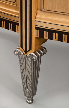 an ornate wooden table with black and gold trimmings on the top, along with two matching drawers