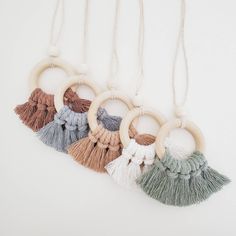 car charm diffusers with tassels hanging from the side on a white background