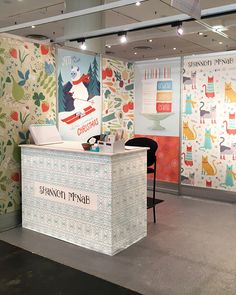 the reception desk is decorated with colorful wallpaper