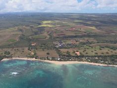 an aerial view of the ocean and land