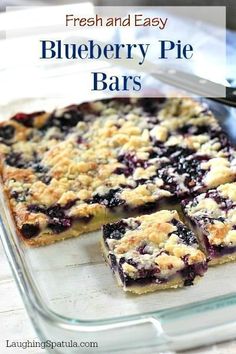 fresh and easy blueberry pie bars in a glass baking dish with a serving utensil