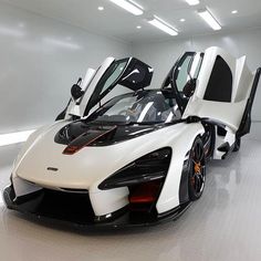 a white and black sports car parked in a garage